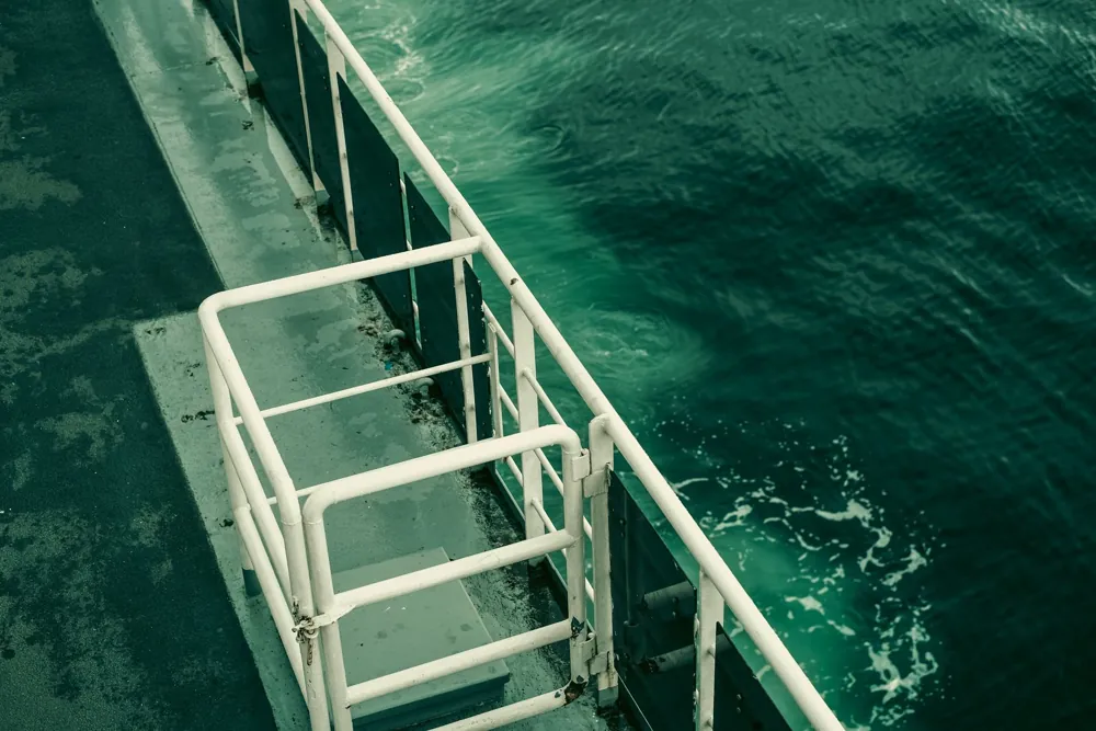 Ship’s deck and railings alongside the open sea