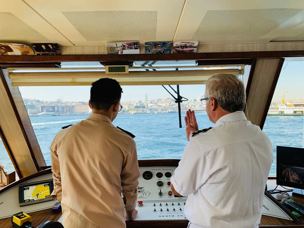 Two maritime professionals coordinating navigation on a vessel’s bridge
